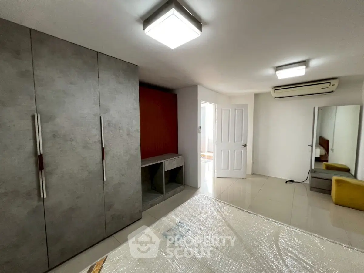 Spacious bedroom with modern wardrobe and air conditioning