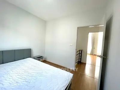 Spacious bedroom with modern decor and natural light