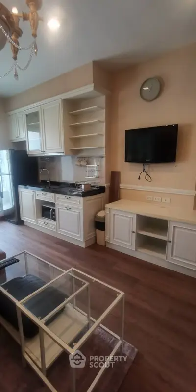 Charming kitchen and living area with modern appliances and elegant decor
