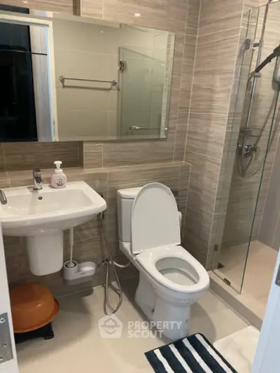 Modern bathroom with sleek fixtures and glass shower enclosure