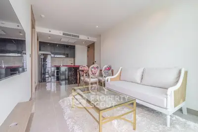 Modern living room with elegant decor and open kitchen layout in luxury apartment.