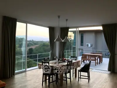 Spacious dining area with panoramic views and modern decor, perfect for family gatherings.