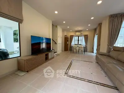Spacious modern living room with elegant decor and large windows for natural light.