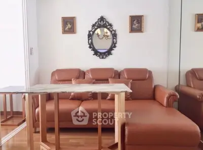 Elegant living room with leather sofa and decorative mirror, perfect for stylish urban living.