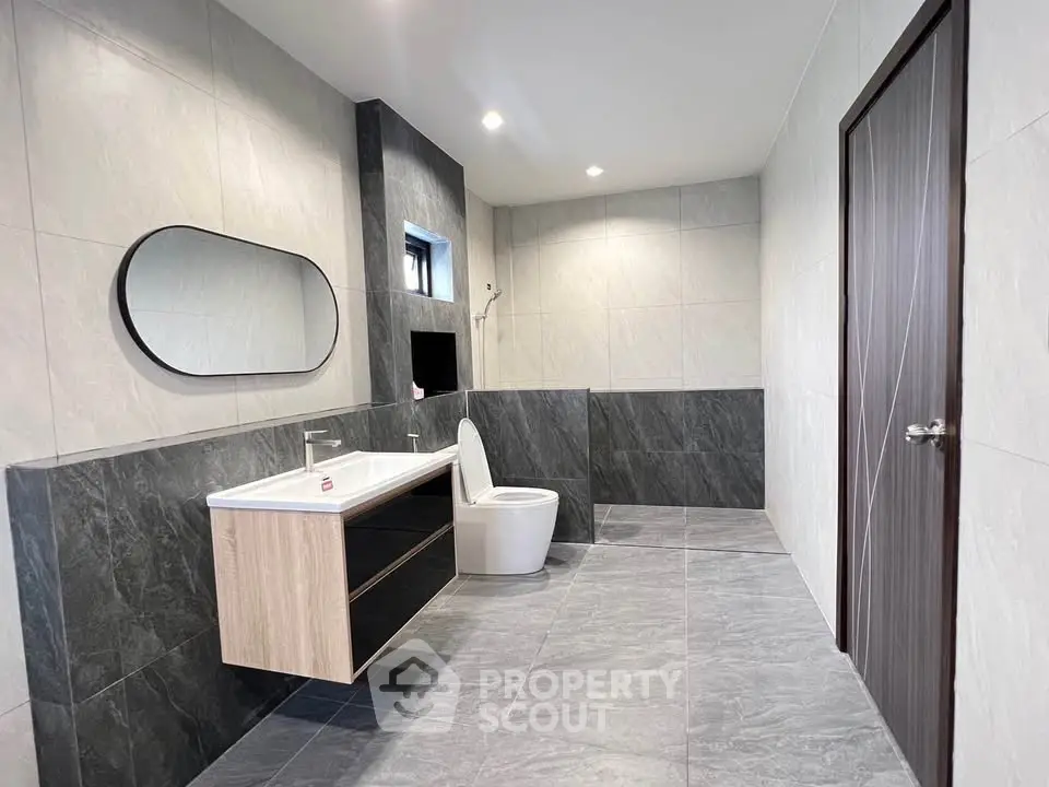 Spacious modern bathroom with sleek design and elegant fixtures.