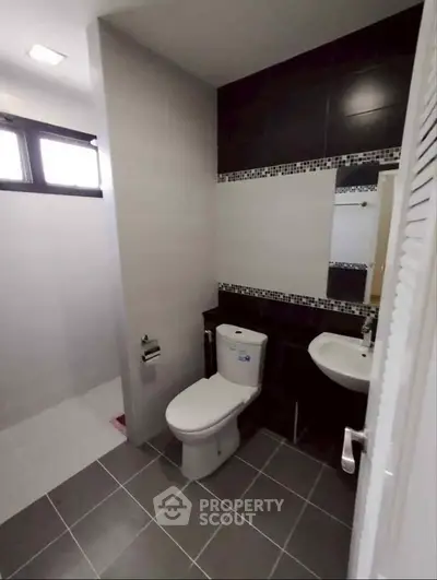Modern bathroom with sleek design and contemporary fixtures in a stylish real estate property.