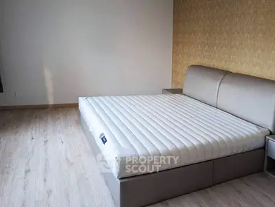 Spacious bedroom with modern bed and elegant flooring