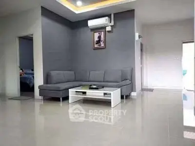 Spacious modern living room with sleek gray sofa and elegant decor
