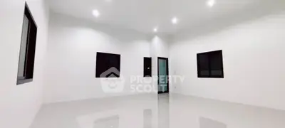 Spacious modern living room with sleek white walls and glossy flooring