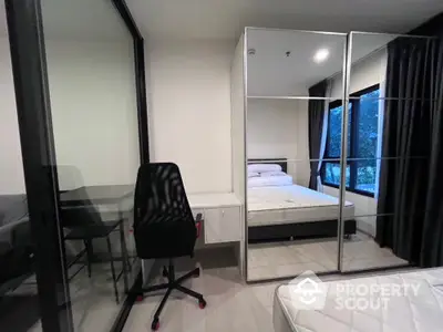 Modern bedroom with mirrored closet and study area in a stylish apartment