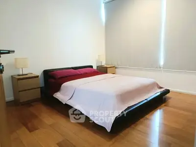 Spacious bedroom with modern design and wooden flooring