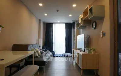 Modern living room with stylish furniture and natural light, perfect for relaxation and entertainment.