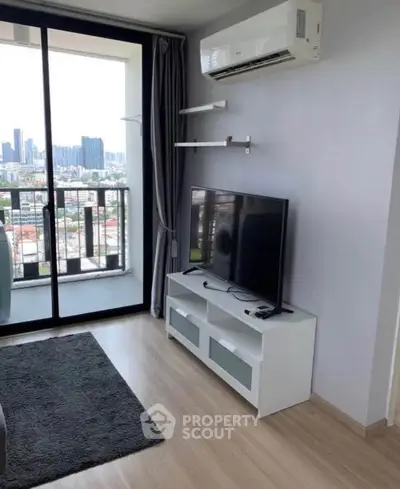Modern living room with city view, featuring sleek TV setup and air conditioning.