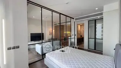 Modern bedroom with glass partition and sleek interior design