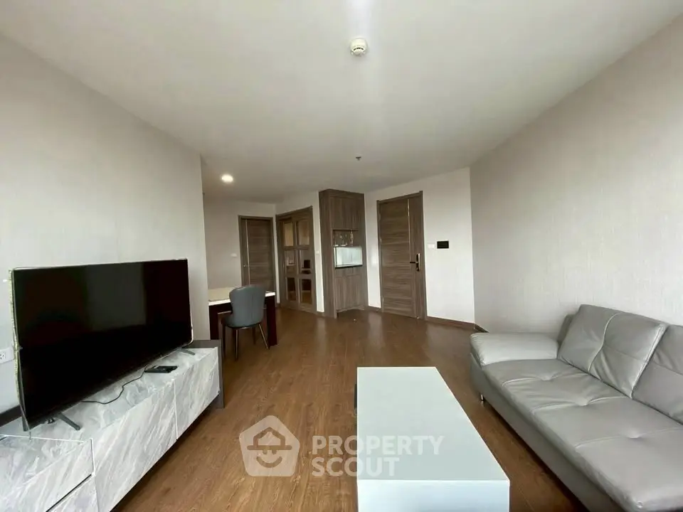 Spacious modern living room with sleek furniture and wooden flooring