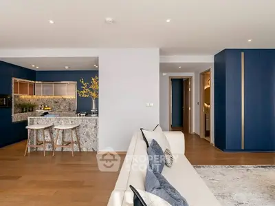 Modern open-plan living room with stylish kitchen and elegant decor.