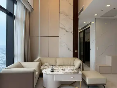 Luxurious modern living room with panoramic city view and elegant marble accents.