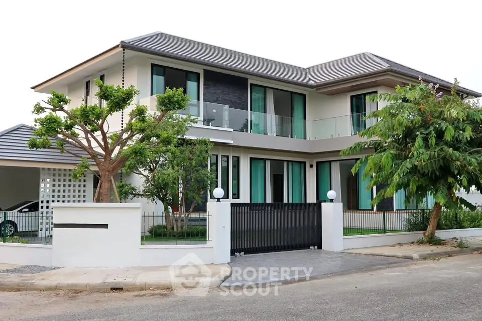 Modern two-story house with sleek design and lush landscaping