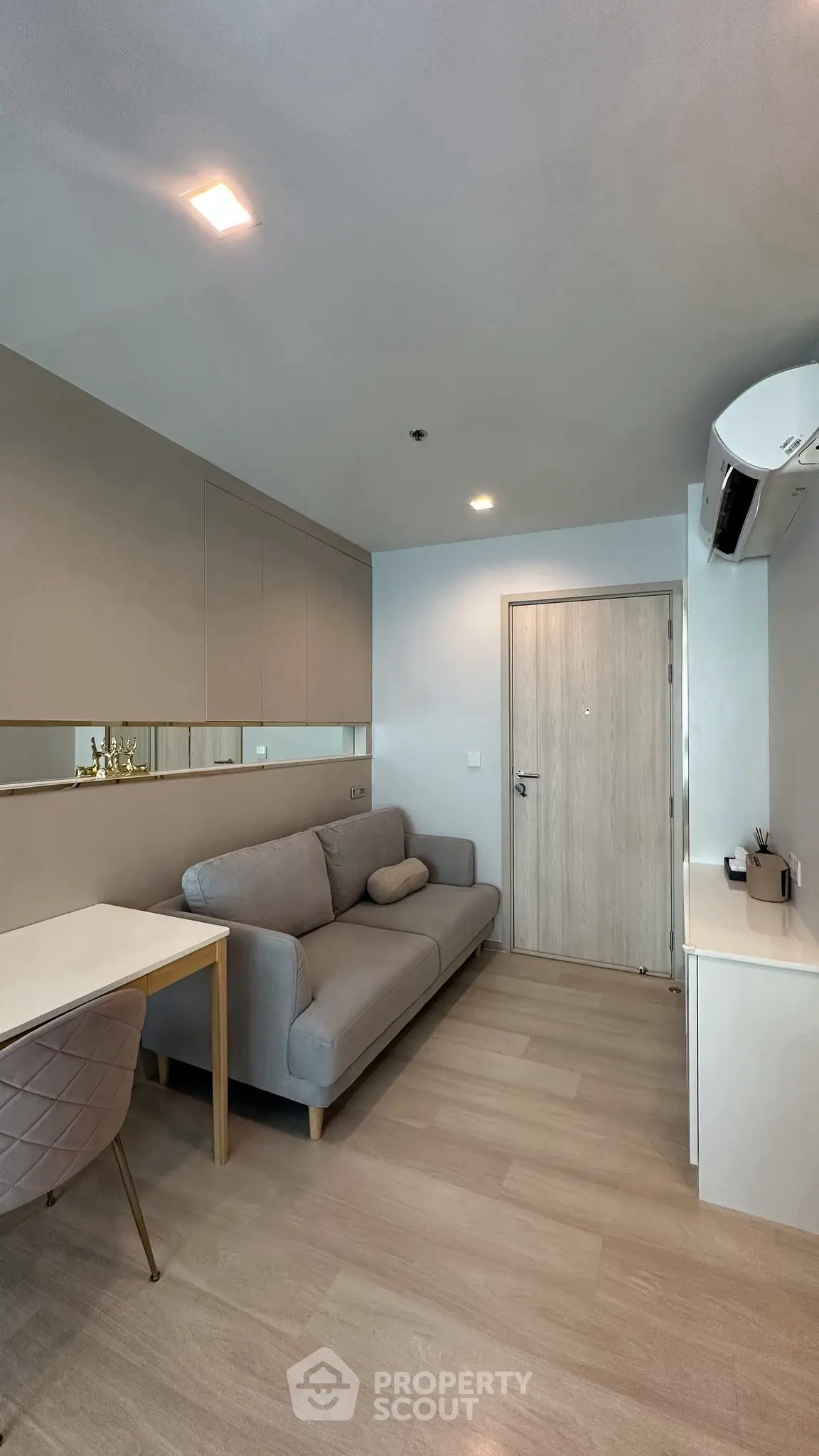Modern living room with sleek design, featuring a comfortable sofa and stylish decor in a cozy apartment.
