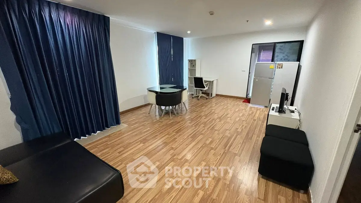 Spacious living room with modern furnishings and wooden flooring