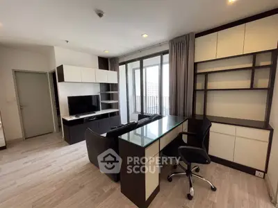 Modern living room with sleek furniture and large windows offering natural light.