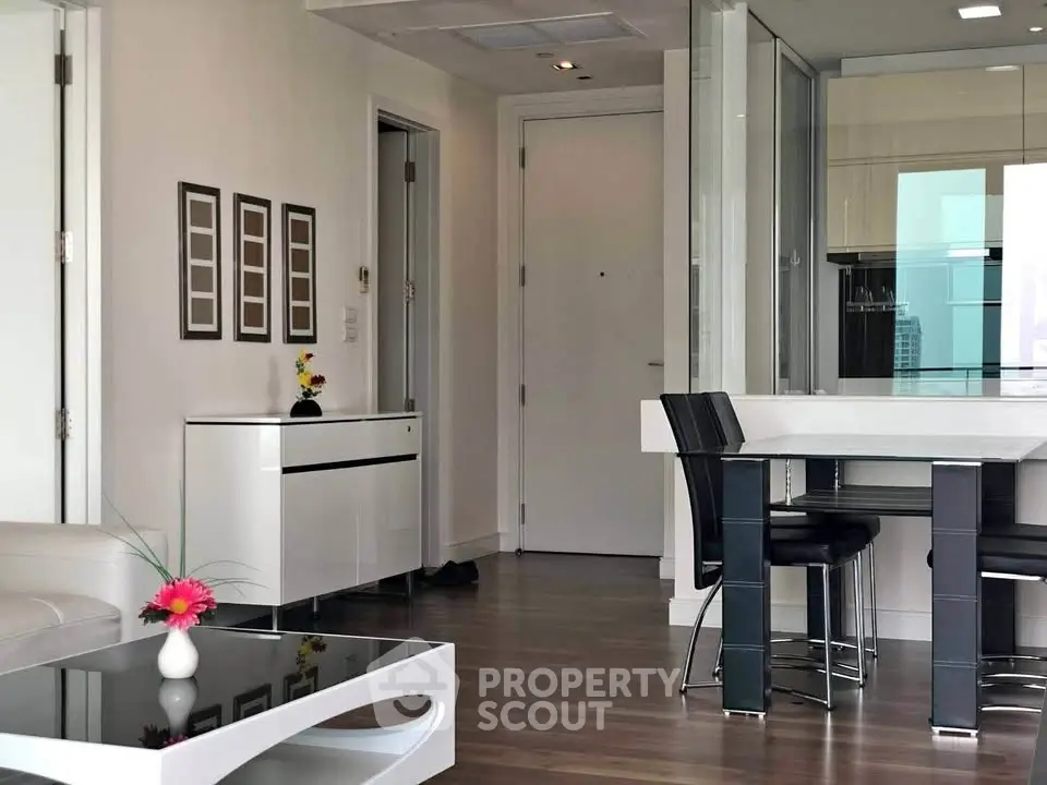 Modern open-plan living room with sleek furniture and hardwood floors