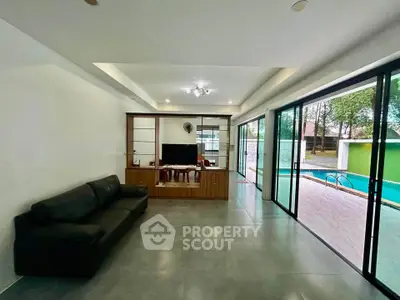 Spacious living room with pool view and modern sliding glass doors