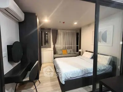Modern bedroom with stylish decor and workspace in a cozy apartment.