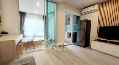 Modern apartment interior with open layout, featuring a cozy living area and sleek kitchen.