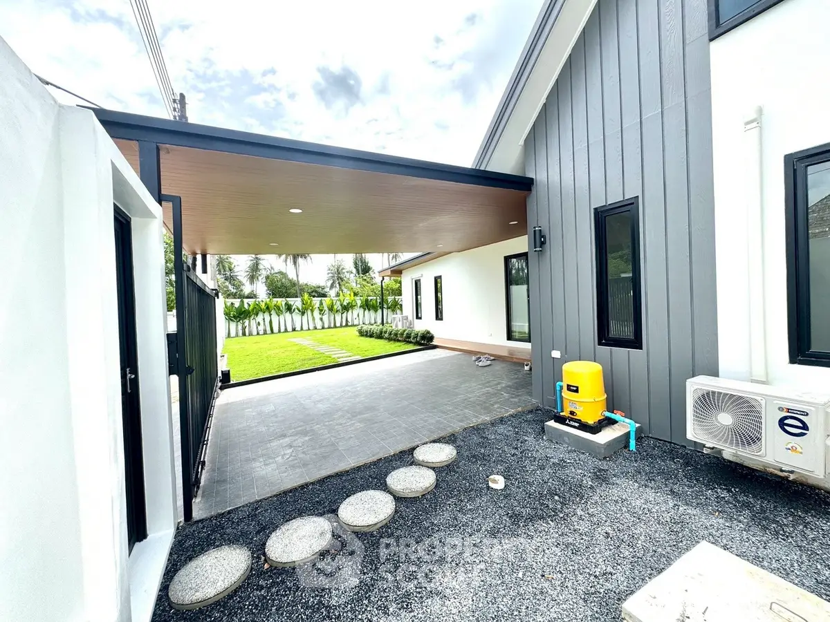 Modern exterior with sleek design, spacious patio, and lush garden in a contemporary home.