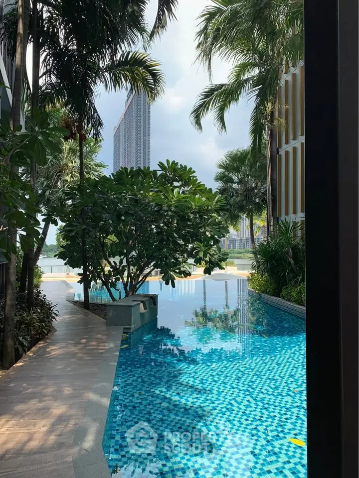 Luxurious poolside view with lush greenery and modern architecture in a high-end residential complex.