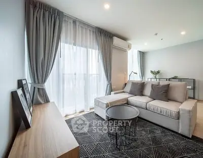 Modern living room with stylish sofa and large window, perfect for relaxation.