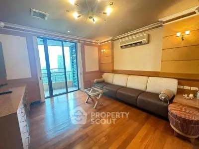 Spacious living room with modern decor and balcony view in a luxury apartment.