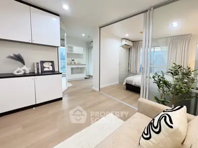 Modern apartment interior with open layout, featuring a cozy living area and stylish bedroom.