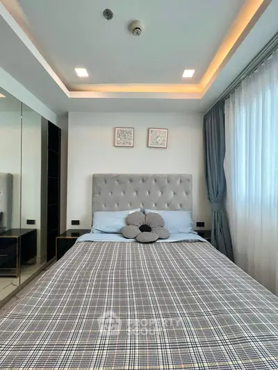 Modern bedroom with stylish decor and ample natural light