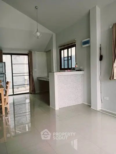 Spacious open-plan living area with modern design and natural light