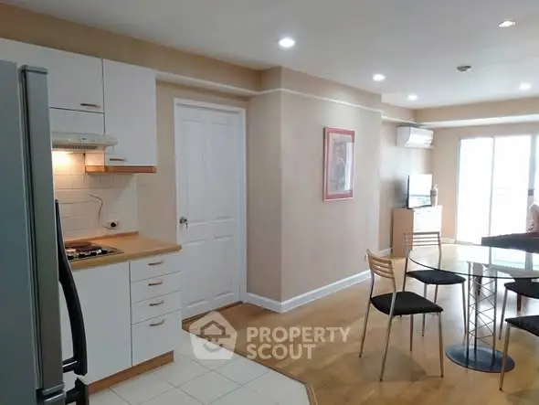 Modern kitchen and dining area with sleek design and natural light