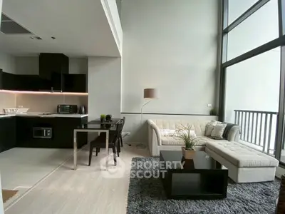Modern open-plan living room with high ceilings and large windows
