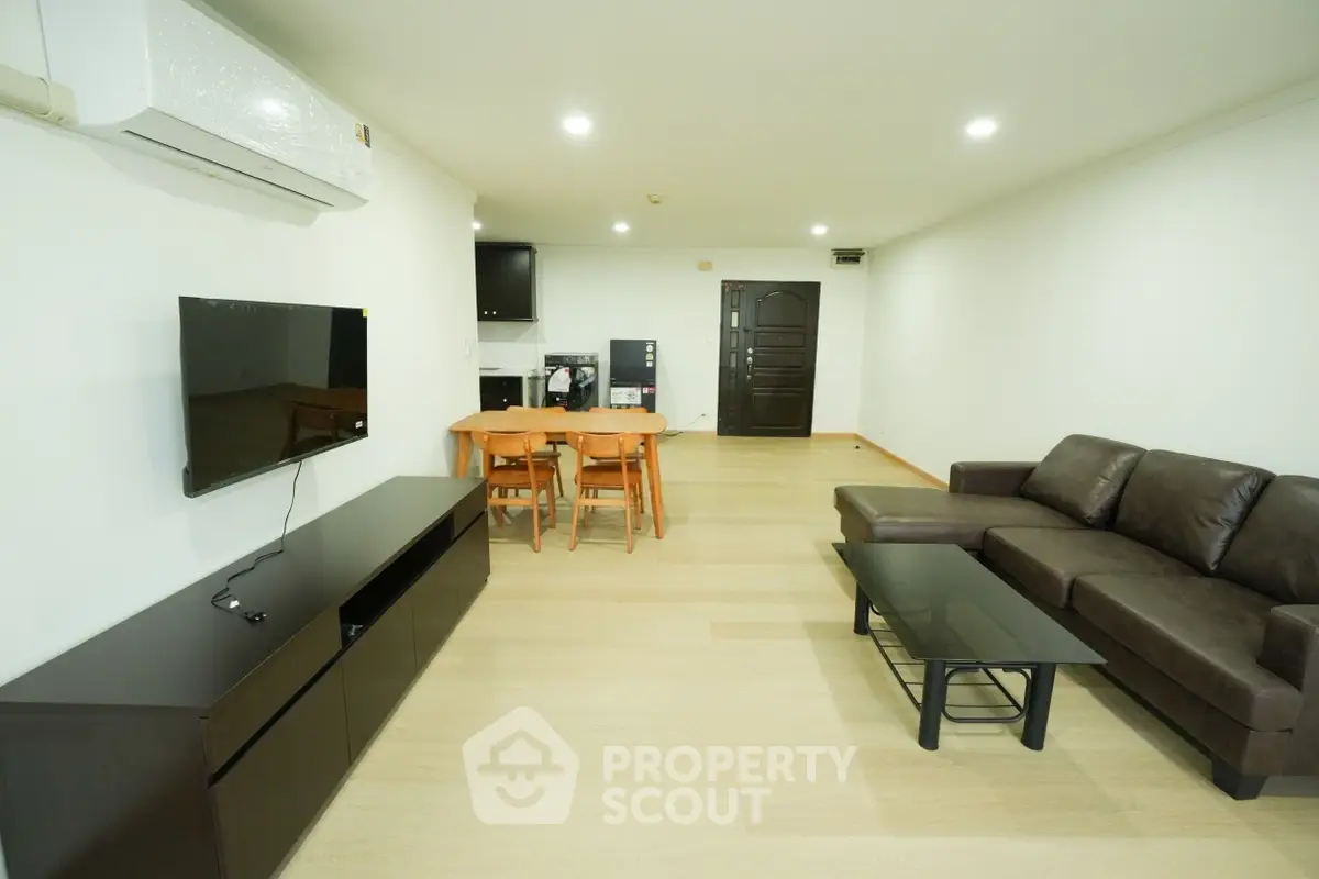 Spacious living room with modern furniture and open layout, perfect for family gatherings.