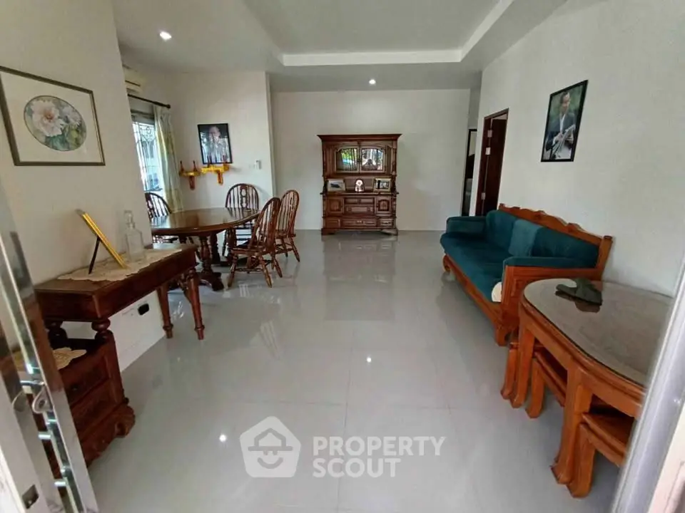 Spacious living room with elegant wooden furniture and polished tile flooring