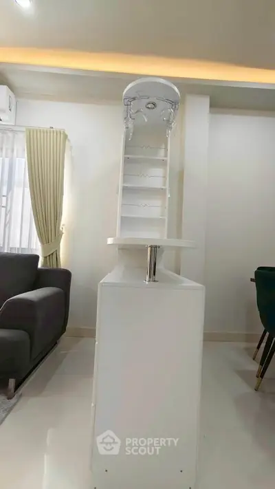 Modern living room with sleek white furniture and elegant lighting