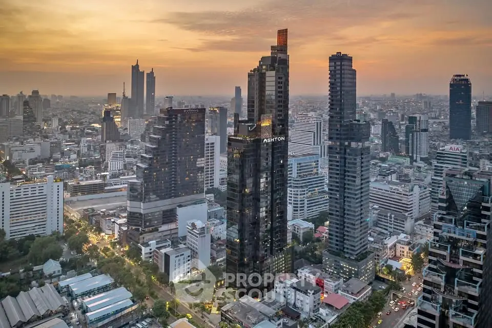 Stunning aerial view of modern city skyline at sunset, showcasing towering skyscrapers and vibrant urban landscape.