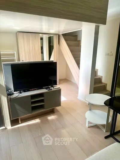 Modern living room with sleek staircase and stylish furniture
