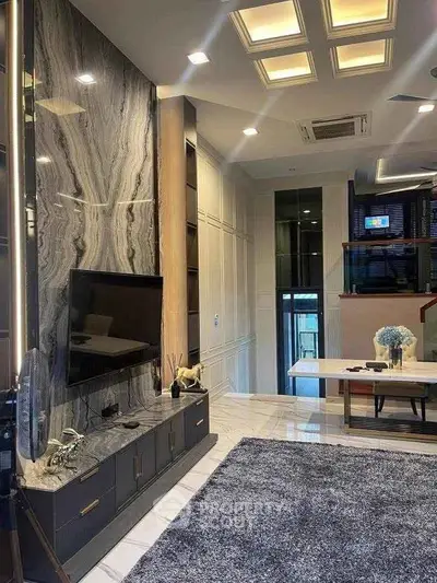 Luxurious modern living room with marble accent wall and stylish decor