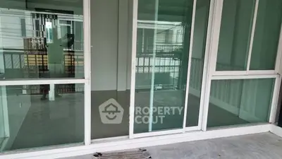 Spacious balcony with sliding glass doors in modern apartment