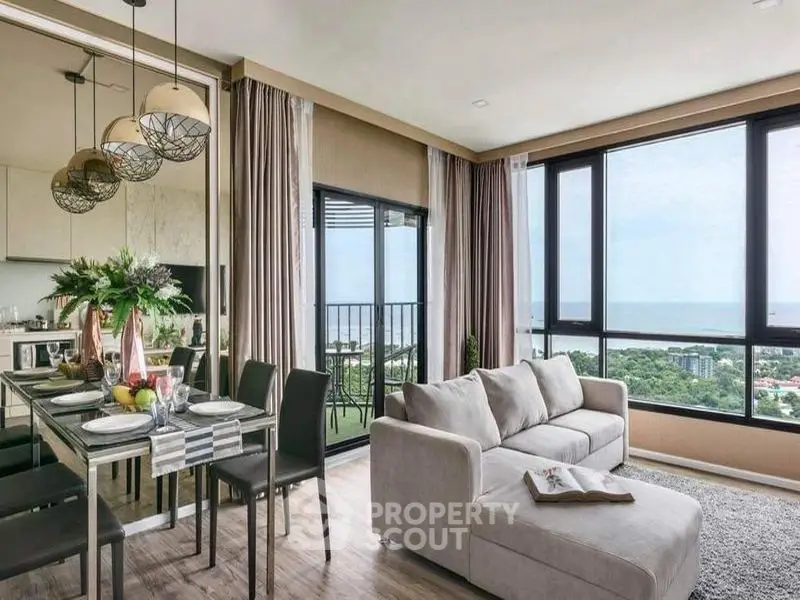 Luxurious living room with ocean view and modern decor in high-rise apartment
