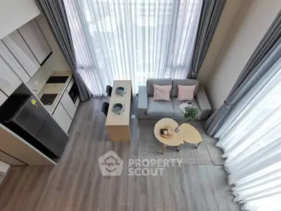 Modern open-plan living room with high ceilings and large windows