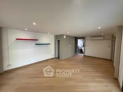 Spacious modern living room with wooden flooring and minimalist design