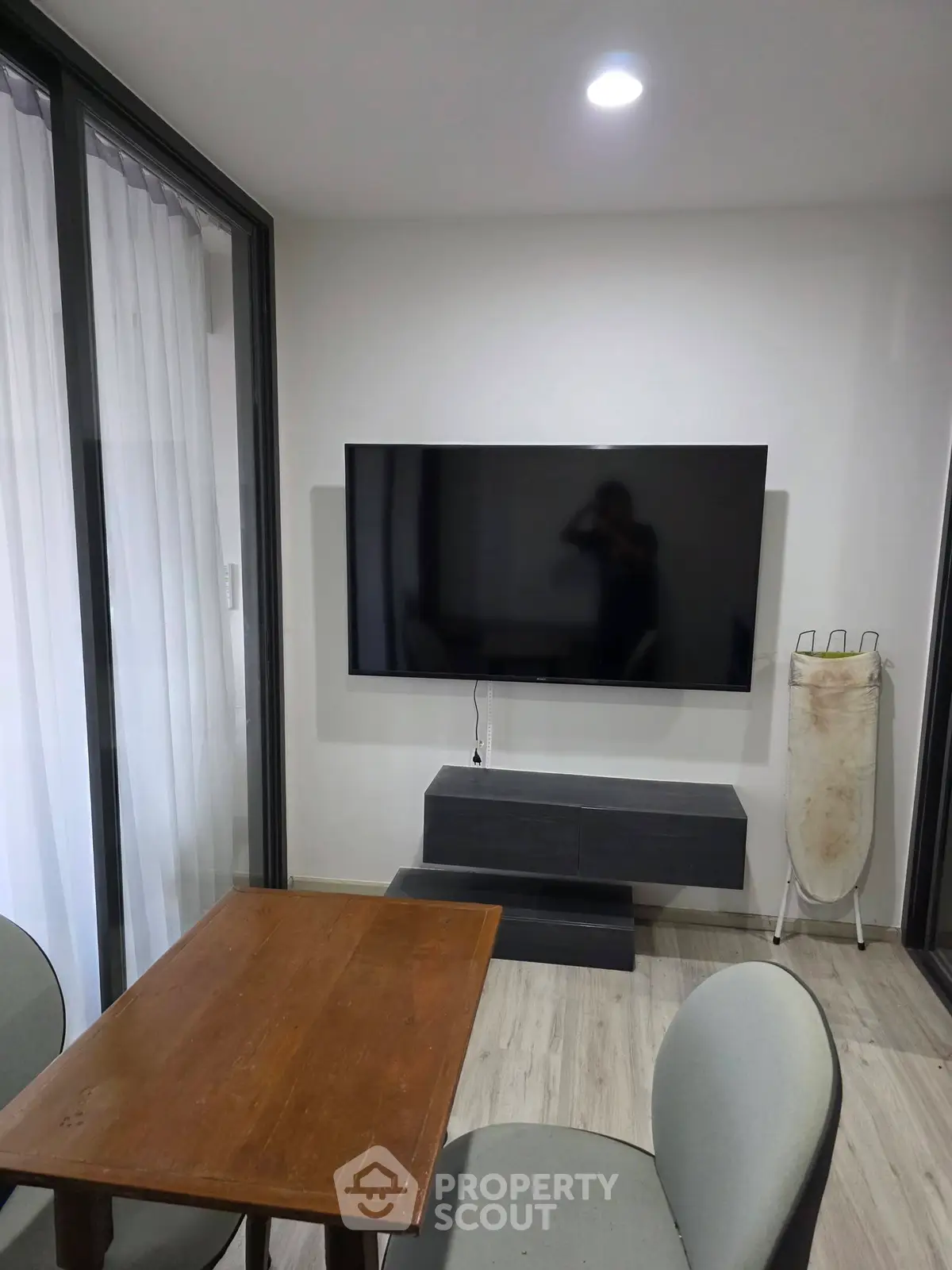 Modern living room with wall-mounted TV and sleek furniture