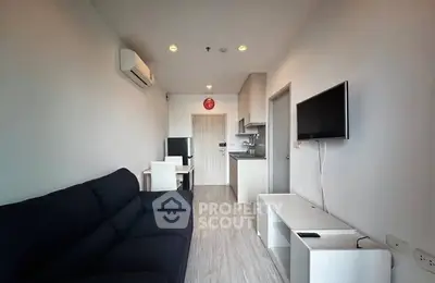 Modern living room with sleek furniture and open kitchen layout